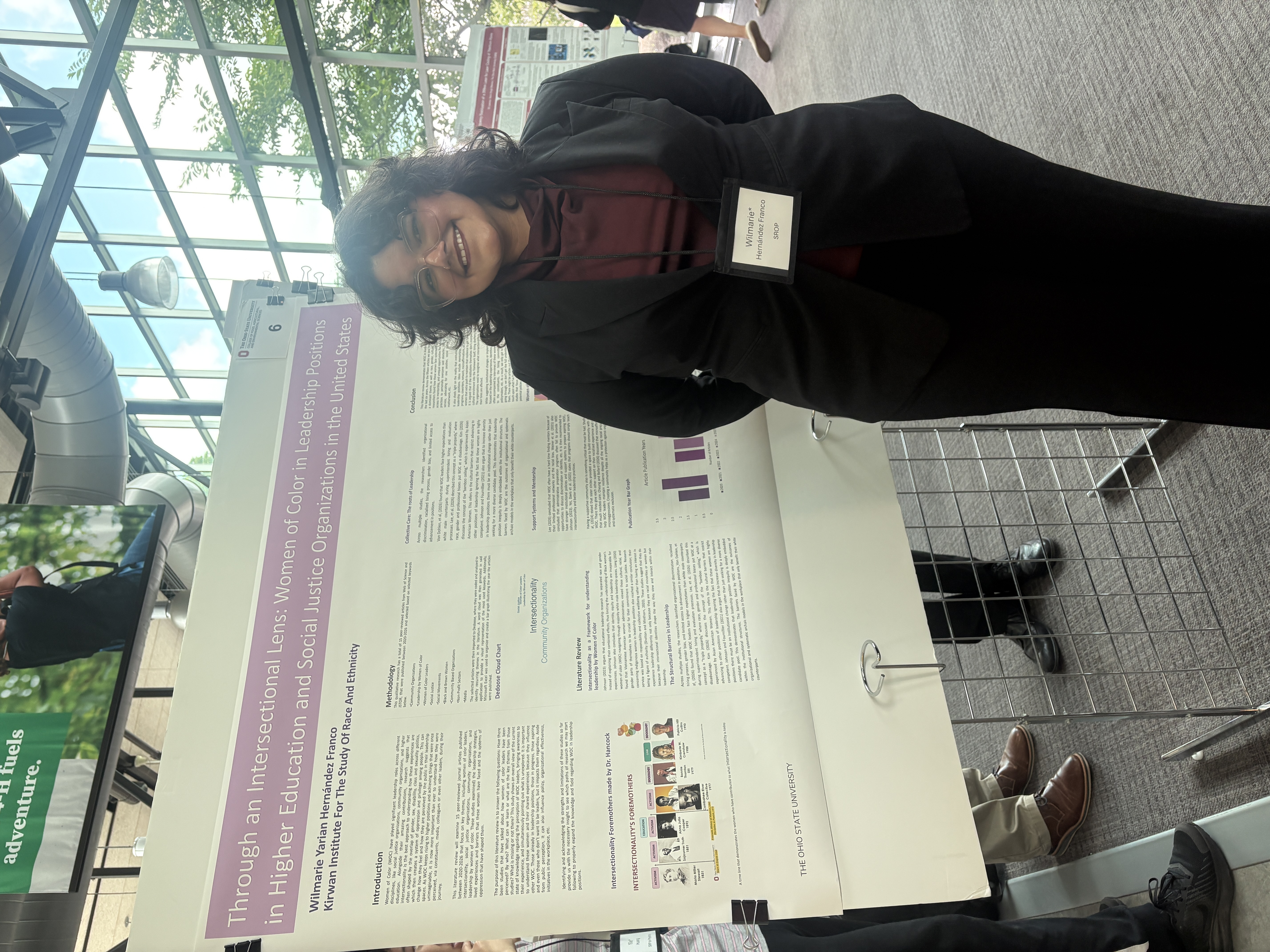 Wilmarie standing in front of her research poster