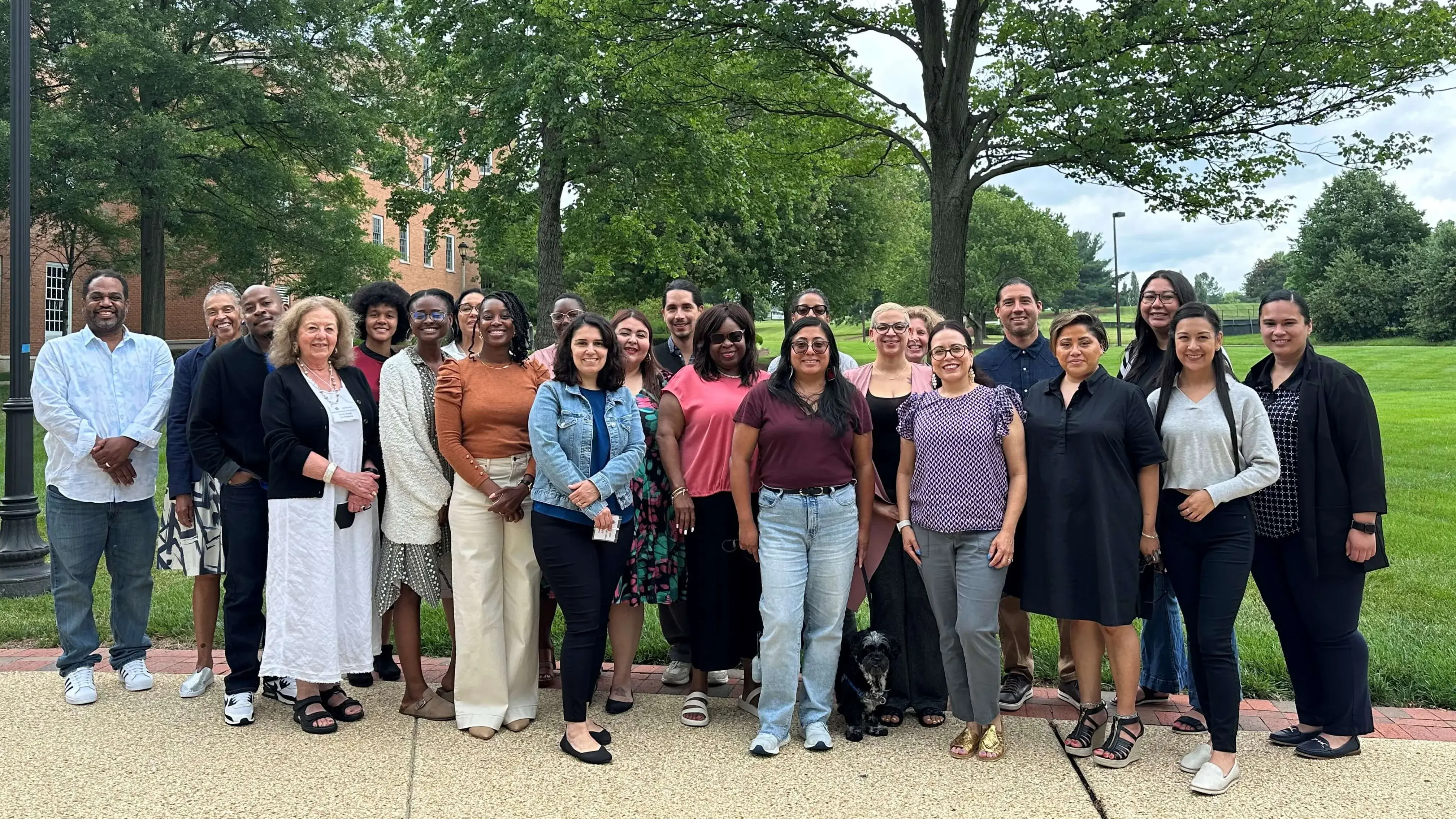 The 2024 IQRMI Cohort poses together outdoors on the University of Maryland campus, standing in rows and smiling for a group photo.