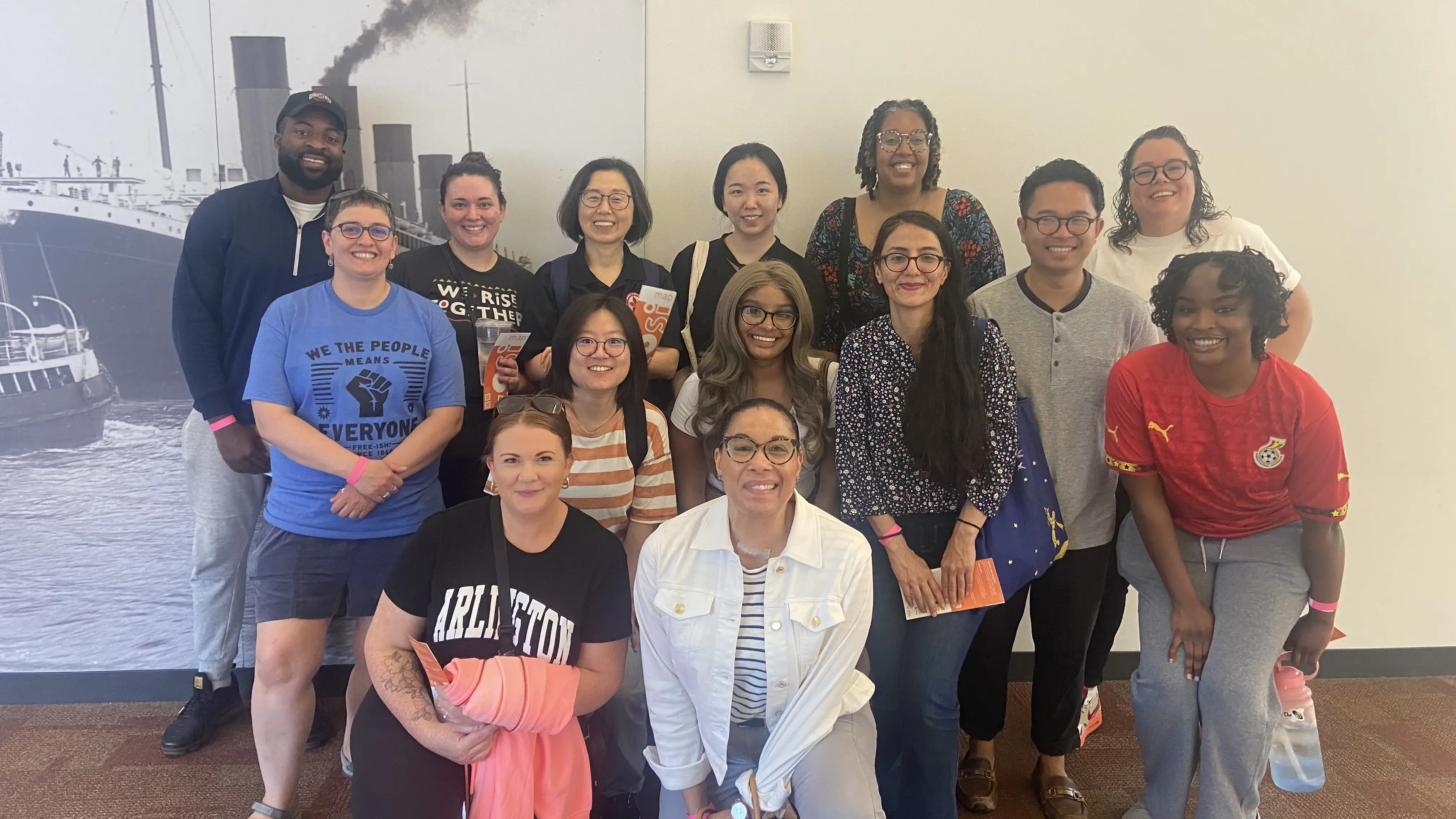 The Kirwan team standing in front of a picture of a boat